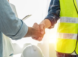 contractor construction worker team hands shaking after plan project contract on workplace