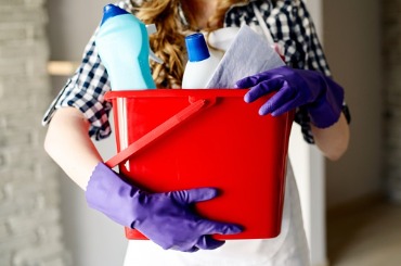 closeup of womans hands holding bucket full of cleaners picture