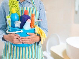 woman with cleaning equipment ready to clean house on bathroom or picture