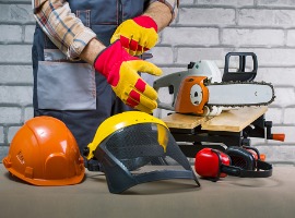 worker puts protective gloves in workshop safety protective equipment picture