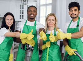 smiling multiracial cleaners showing thumbs up