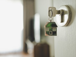 open the door and door handle with a key and a keychain shaped house property investment