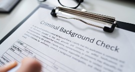 hand filling criminal background check application form picture