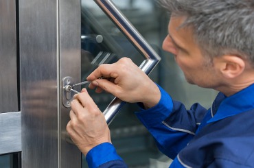 male lockpicker fixing door handle at home picture