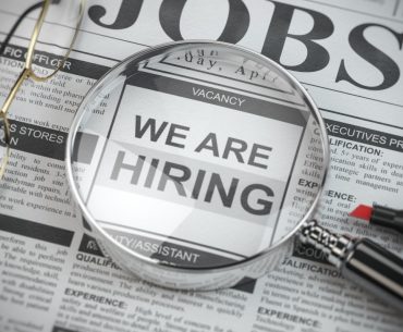 we are hiring job search and employment concept magnified glass with picture