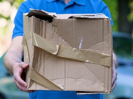 male courier showing damaged box cheap parcel delivery poor shipment quality