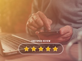 customer review and five star rating concept using smartphone and laptop for online service
