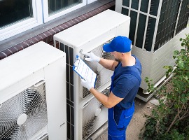 an electrician men checking air conditioning unit