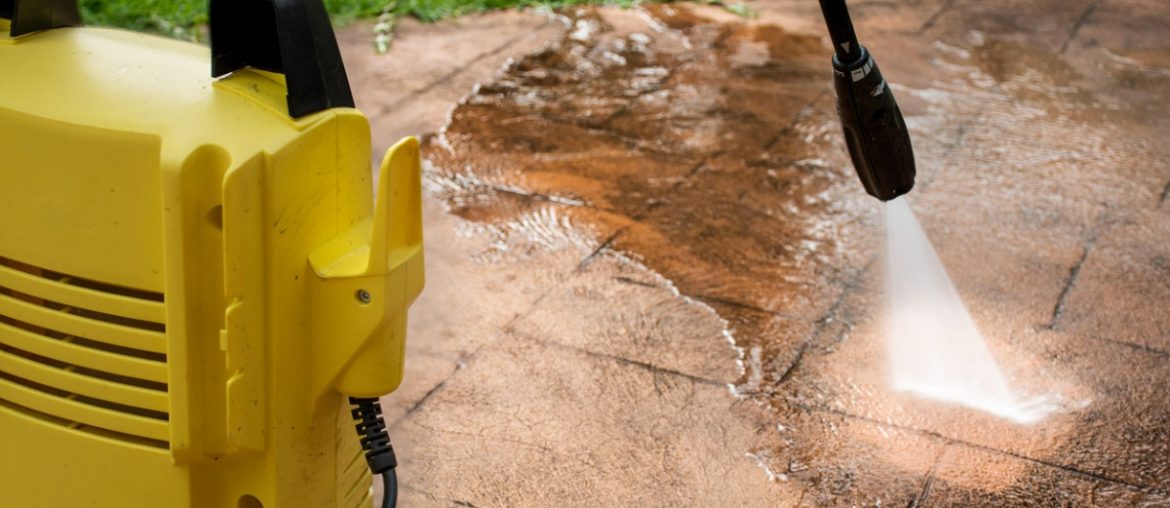 cleaning backyard paving tiles with pressure washer picture