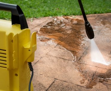 cleaning backyard paving tiles with pressure washer picture