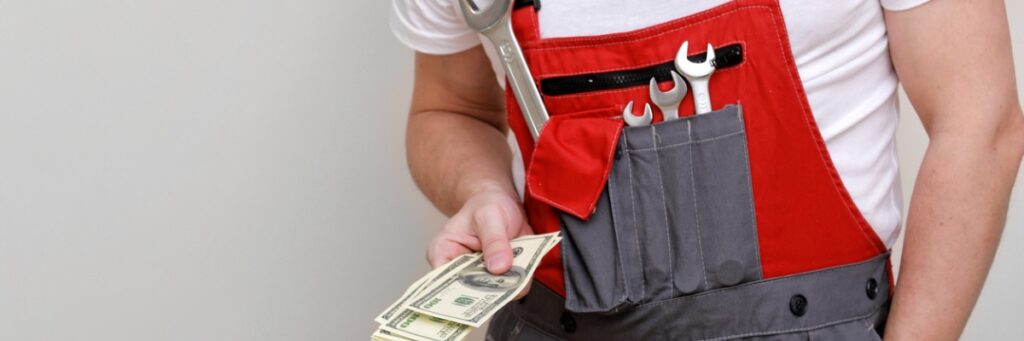 cropped photo of worker in red uniform protective hard hat holding bundle of dollars cash