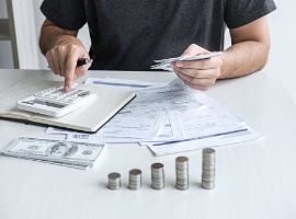 images of stacking coin pile and husband using calculator to calculating expenditure receipt