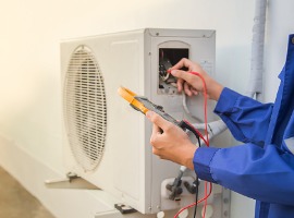 technician checking the operation of the air conditioner