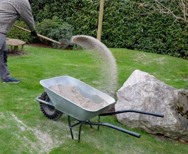 after pruning a bunch of lawn gardeners apply silica white sand picture