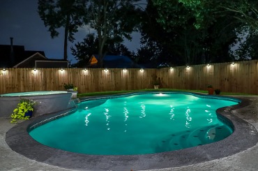 backyard swimming pool and hot tub at night picture