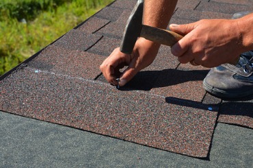 closeup of asphalt shingles installation on the roof edge a roofer is picture