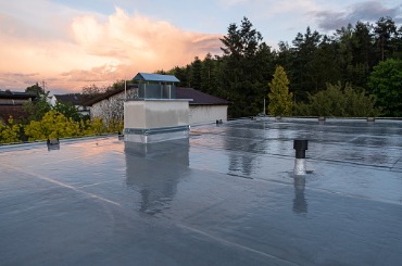 flat roof covered with bitumen membrane and silver lacquer with on a picture