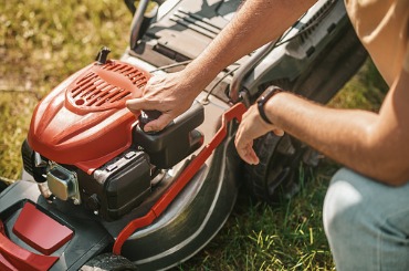 male hands adjusting lawn mower outdoors picture