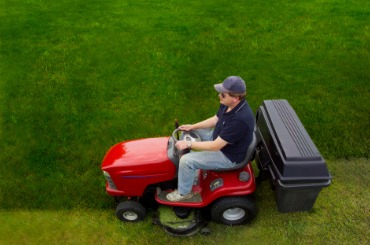 man riding a lawn tractor picture