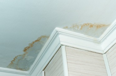 neighbors have a water leak water damaged ceiling closeup of a stain picture