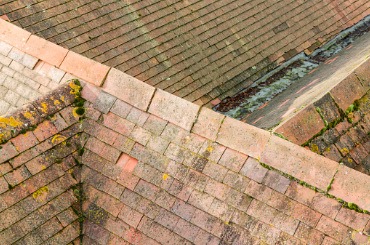 old tiled roof with ridge tiles and valley on houses uk picture