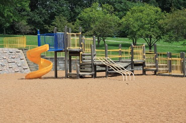 vintage playground with yellow slide and pea gravel picture