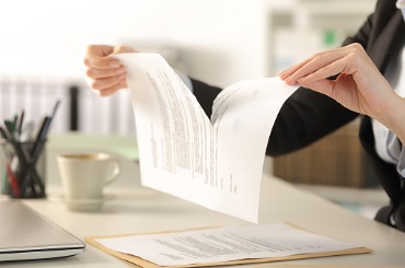 business woman hands breaking document at the office picture