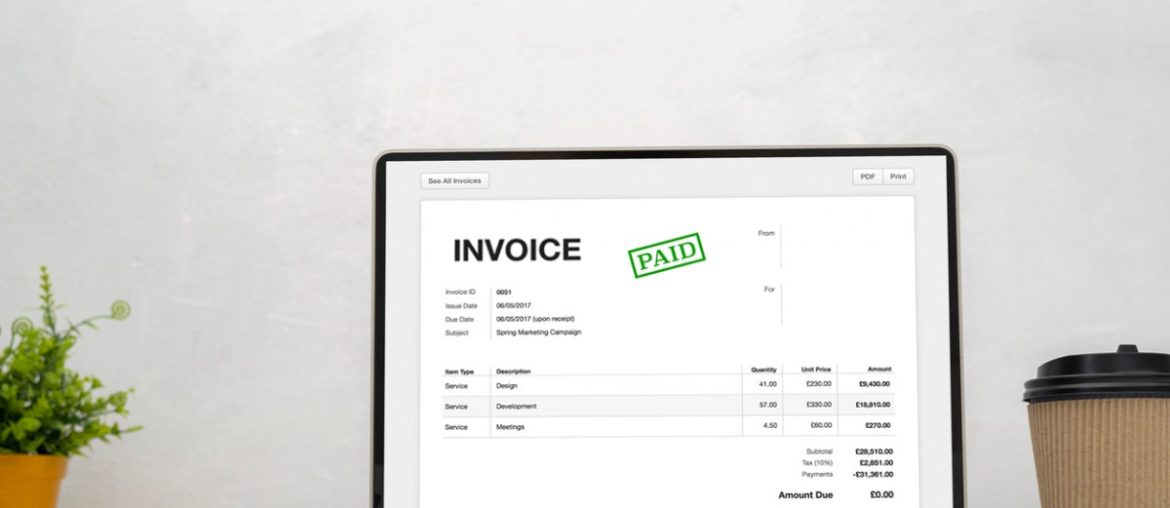 laptop with an invoice on the screen