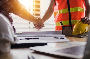 handshake of two business man after architect working and planning picture