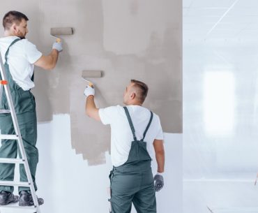 man on ladder painting wall picture