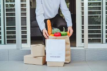 woman hand accepting contactless bag of food fruit vegetable delivery picture