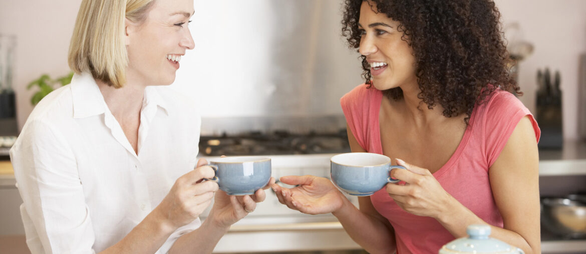 Two women chatting while drinking tea