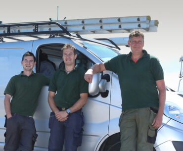 field service workers standing by van